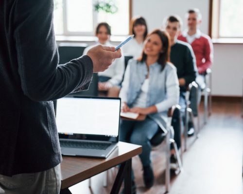 everyone-is-smiling-listens-group-people-business-conference-modern-classroom-daytime (1)